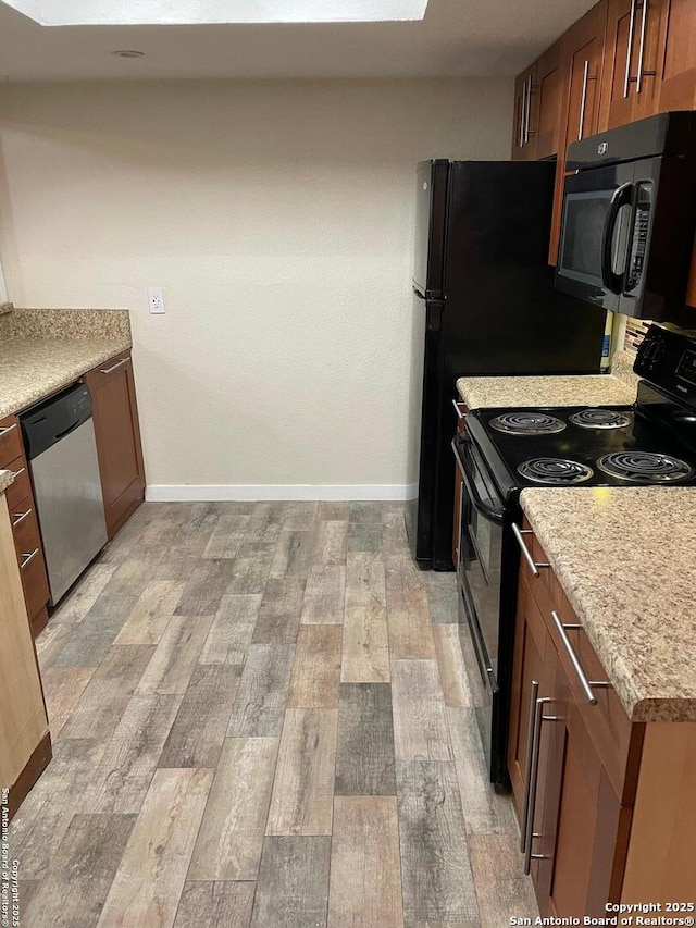 kitchen featuring light hardwood / wood-style flooring and black appliances