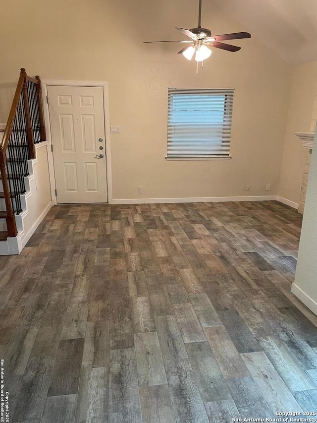 interior space with lofted ceiling, dark hardwood / wood-style floors, and ceiling fan