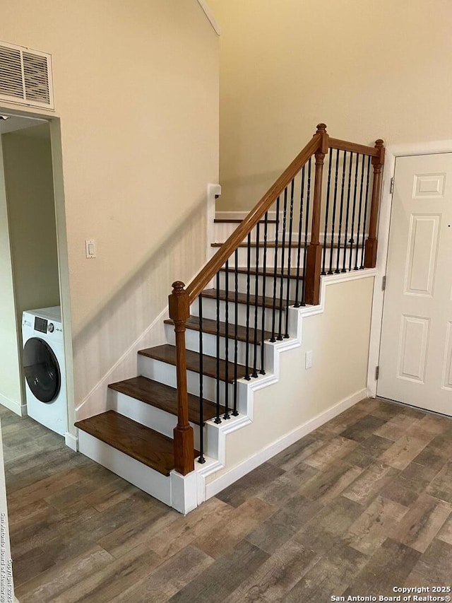 staircase featuring hardwood / wood-style flooring and washer / clothes dryer