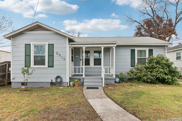 bungalow-style house featuring a front lawn and covered porch