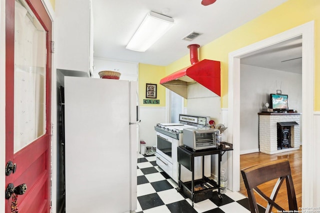 kitchen featuring white refrigerator and range with gas cooktop