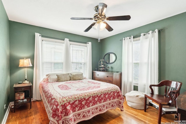 bedroom with hardwood / wood-style floors and ceiling fan