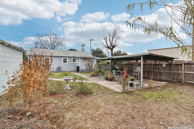 view of yard with cooling unit and a patio