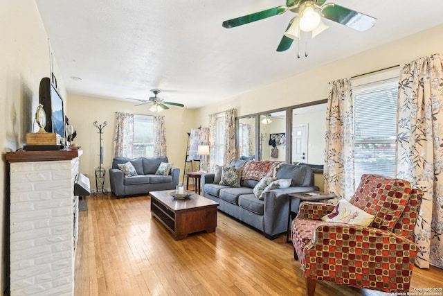 living room featuring ceiling fan and light wood-type flooring