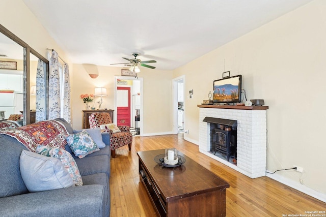 living room featuring wood-type flooring and ceiling fan