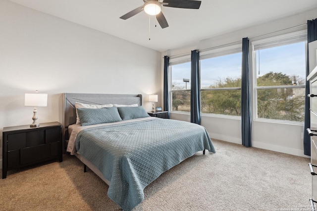 carpeted bedroom featuring lofted ceiling and ceiling fan