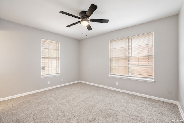 carpeted spare room with ceiling fan