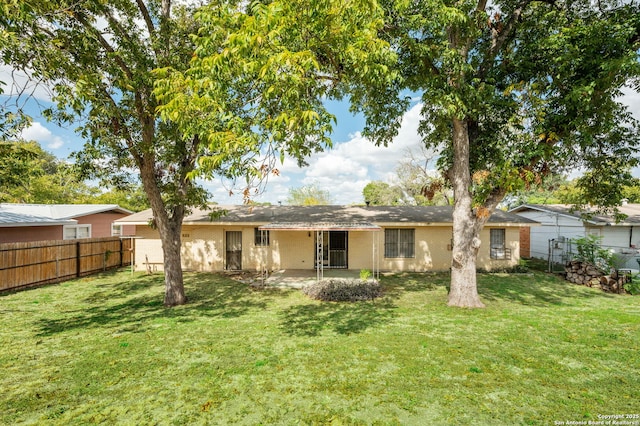 rear view of house featuring a lawn