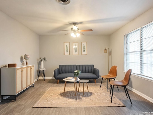 living room with ceiling fan and hardwood / wood-style floors