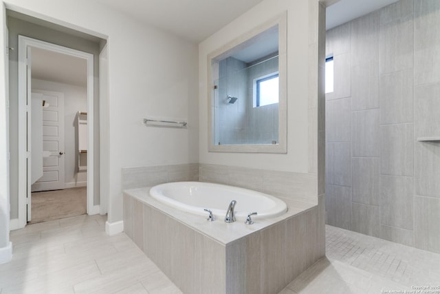 bathroom featuring tile patterned flooring and plus walk in shower