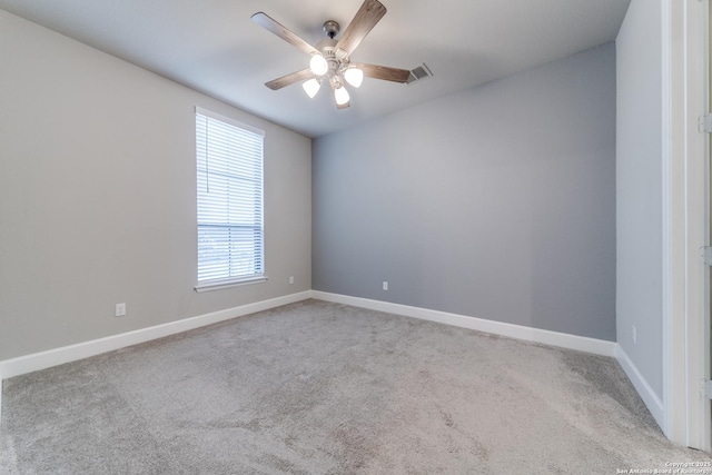 empty room featuring ceiling fan and light carpet