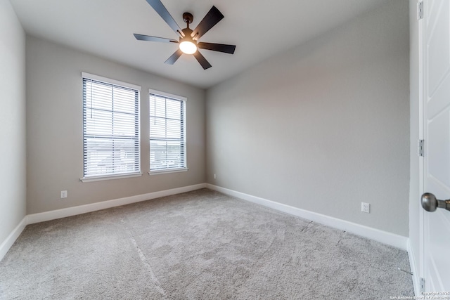 carpeted spare room featuring ceiling fan