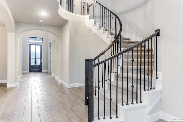 foyer featuring hardwood / wood-style floors and a towering ceiling