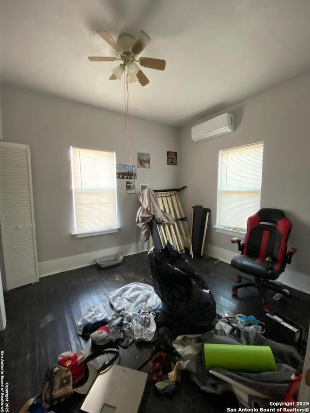 dining room featuring ceiling fan, dark wood-type flooring, and a wall unit AC