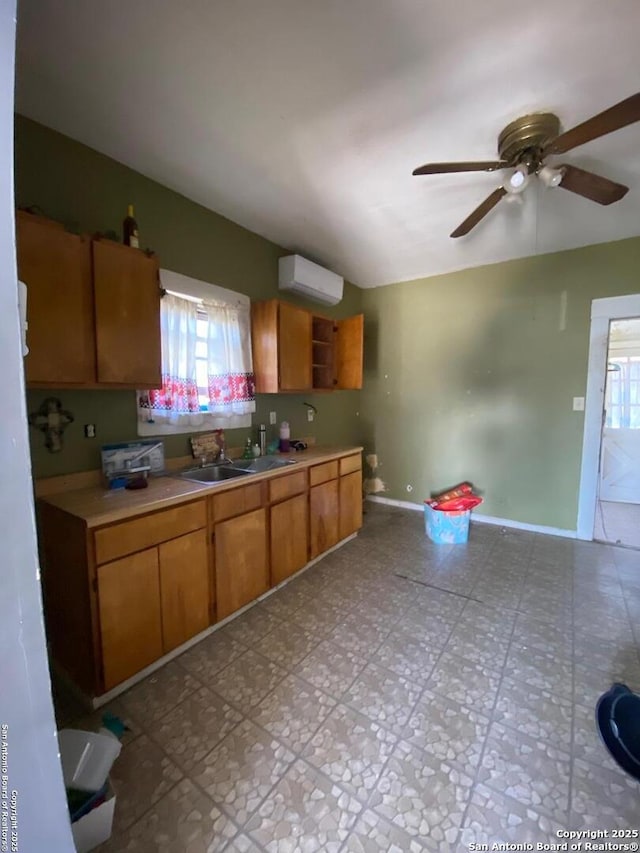 kitchen with ceiling fan, a wall mounted AC, and sink