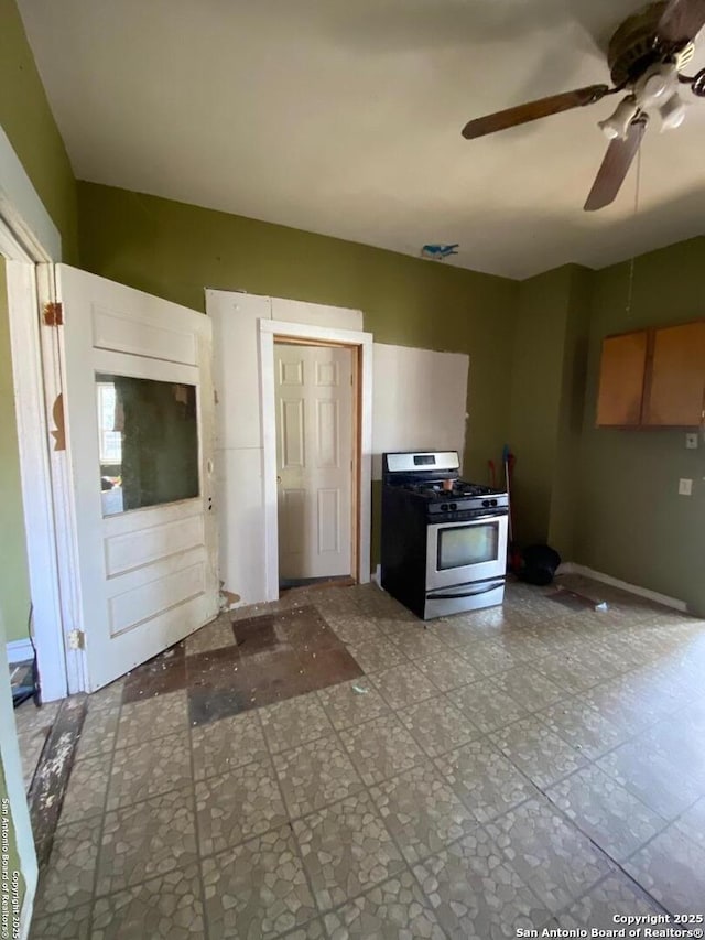 kitchen featuring stainless steel gas range and ceiling fan