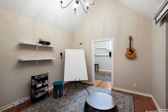 interior space featuring wood-type flooring, high vaulted ceiling, and a chandelier