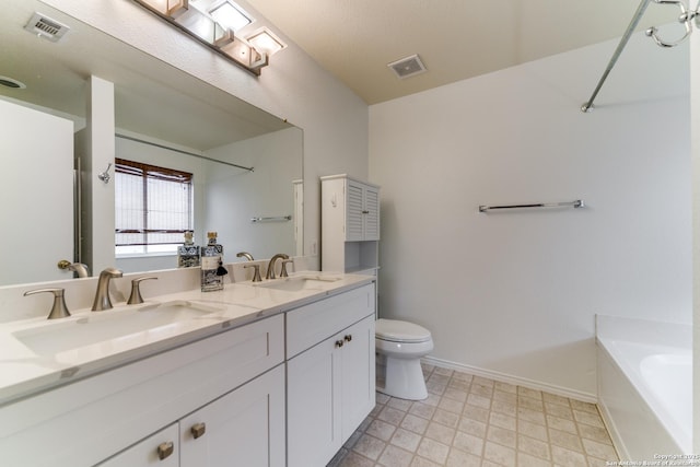 bathroom featuring vanity, toilet, and a bathing tub