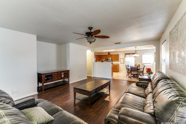 living room with wood-type flooring and ceiling fan