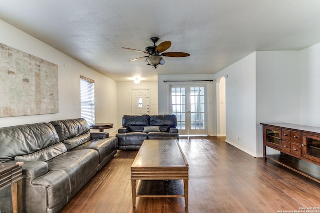 living room featuring hardwood / wood-style floors, ceiling fan, and french doors