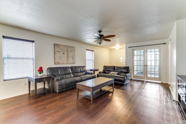 living room with ceiling fan, dark hardwood / wood-style floors, a textured ceiling, and french doors