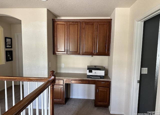 kitchen featuring carpet flooring and a textured ceiling