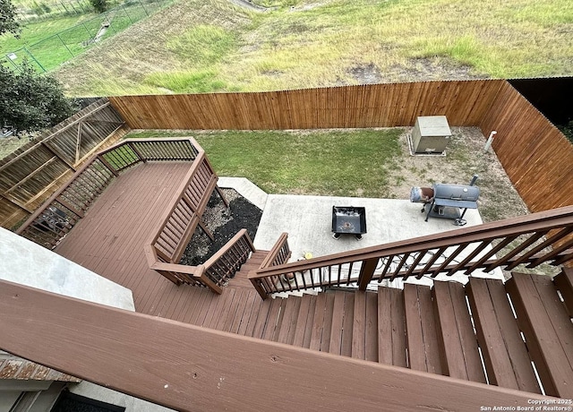 deck with area for grilling and a yard