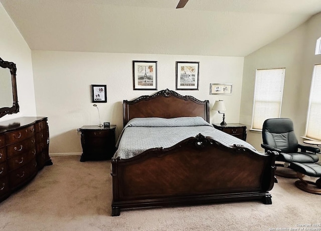 carpeted bedroom with ceiling fan and vaulted ceiling