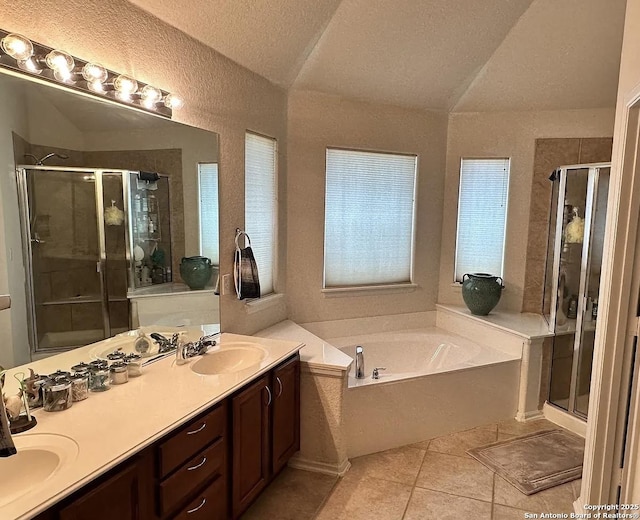 bathroom featuring tile patterned flooring, vanity, vaulted ceiling, and plus walk in shower