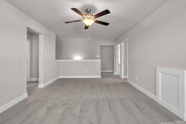 empty room with light carpet and ceiling fan