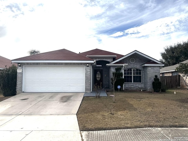 single story home featuring a garage and a front yard