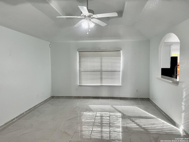 spare room featuring vaulted ceiling and ceiling fan