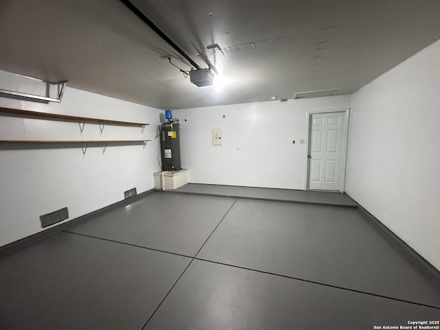 garage with a garage door opener and electric water heater