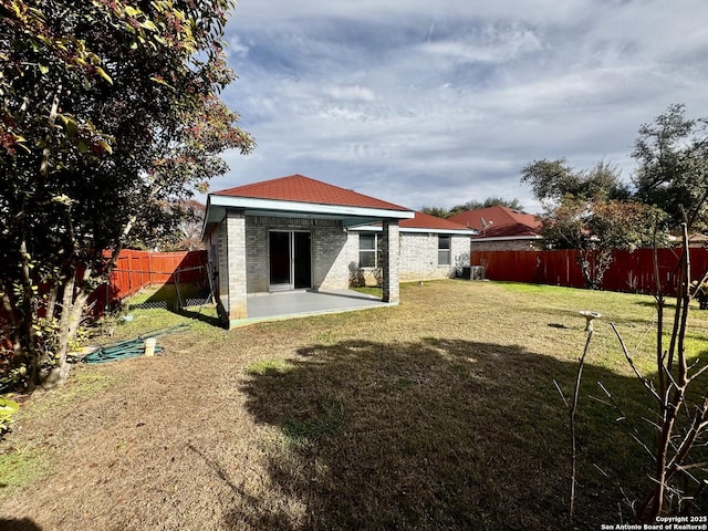 back of house featuring a patio and a lawn