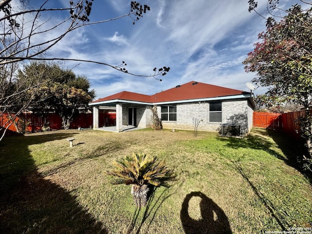 back of house featuring a yard and a patio area