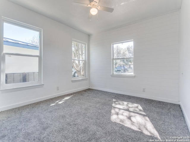 empty room featuring ceiling fan and carpet floors