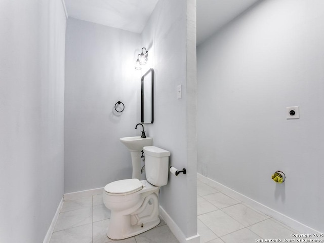 bathroom with tile patterned floors and toilet