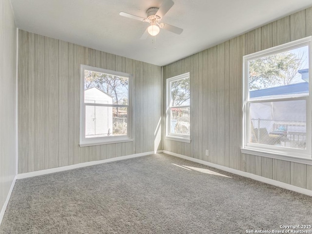 unfurnished room featuring carpet and ceiling fan