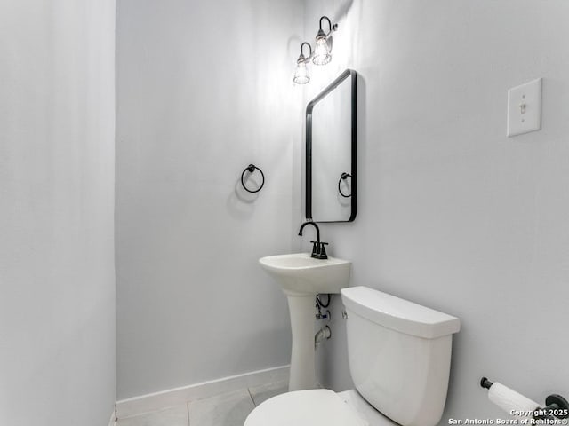 bathroom featuring toilet and tile patterned flooring