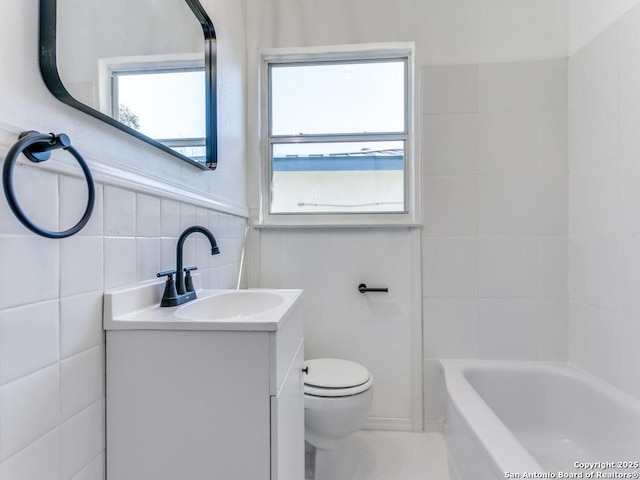 full bathroom featuring vanity, plenty of natural light, tile walls, and toilet