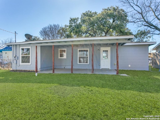 back of property featuring a patio and a lawn