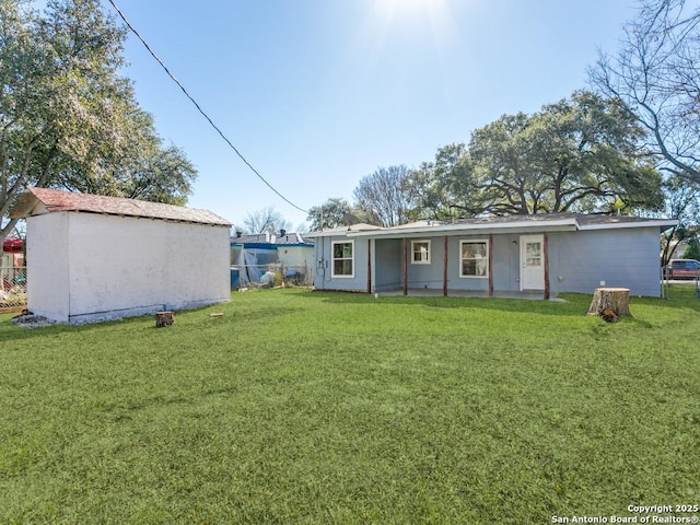 rear view of house featuring a lawn