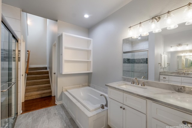 bathroom with vanity and separate shower and tub