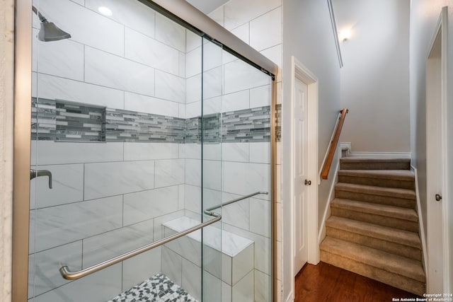 bathroom featuring wood-type flooring and a shower with door