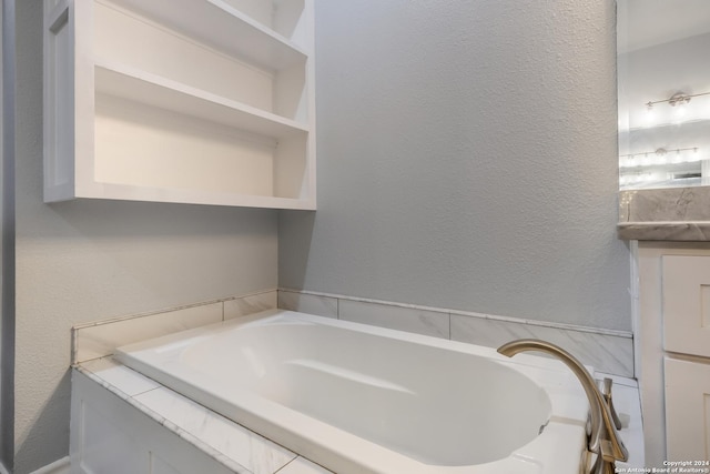 bathroom with vanity and a tub to relax in