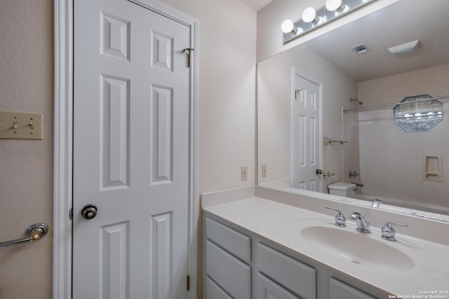 full bathroom featuring vanity, toilet, and washtub / shower combination