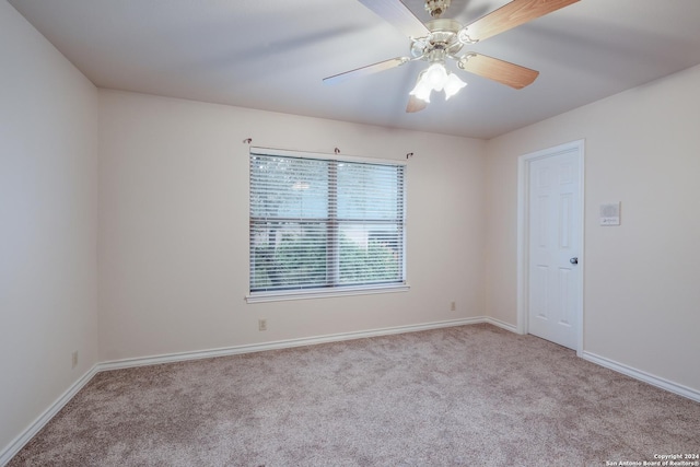 carpeted empty room featuring ceiling fan