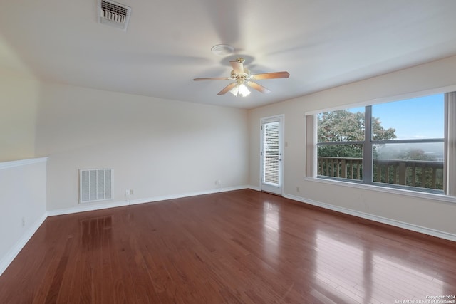 empty room with dark wood-type flooring and ceiling fan