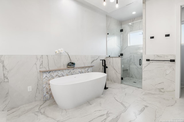 bathroom featuring shower with separate bathtub