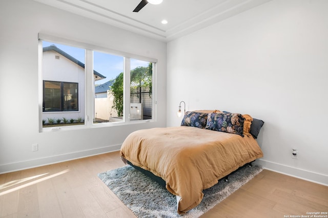 bedroom with ceiling fan and wood-type flooring